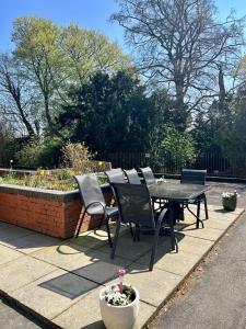 a table and chairs sitting on a patio at Bright and spacious two bed apartment with roof terrace in Hoddesdon in Hoddesdon