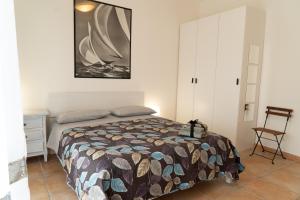 a bedroom with a bed and a chair at La Terrazza sul Reno in Casalecchio di Reno