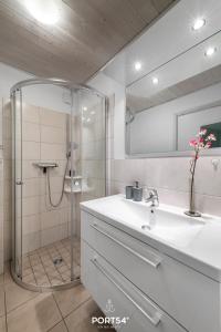a bathroom with a shower and a sink and a mirror at Ferienhaus Meerblick Marina Wendtorf in Wendtorf
