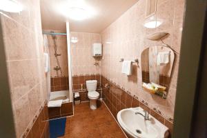 a bathroom with a toilet and a sink at Hotel ABA in Novokuznetsk