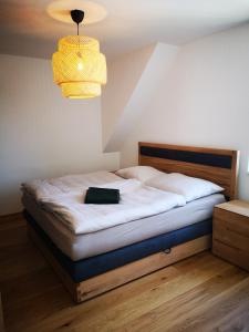 a bedroom with a bed with a black book on it at Cosy Apartment next to the center of Graz in Graz