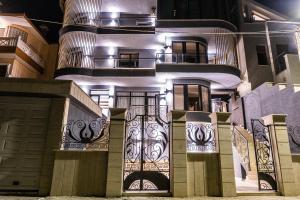 a house with a gate with lights on it at Vila Kace in Korçë