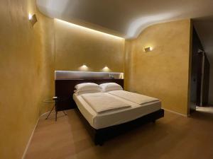 a bedroom with a bed in a room at DelleArti Design Hotel in Cremona