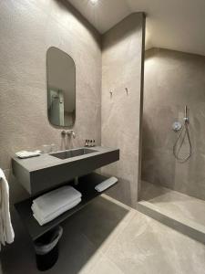 a bathroom with a sink and a shower at DelleArti Design Hotel in Cremona