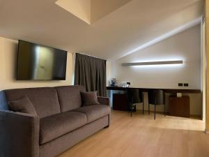 a living room with a couch and a table at DelleArti Design Hotel in Cremona