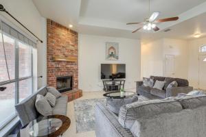 a living room with two couches and a fireplace at Lovely Killeen Retreat with Brick Fireplace! in Killeen