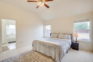 a bedroom with a bed and a ceiling fan at Lovely Killeen Retreat with Brick Fireplace! in Killeen