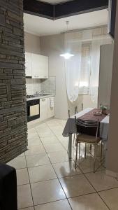 a kitchen and dining room with a table and chairs at Casa di Paola in Asti +11 photos