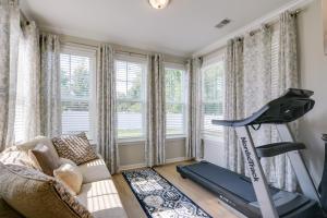 a living room with a treadmill and a couch at Greer Family Home with Library, Sunroom and Backyard! in Duncan