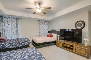 a bedroom with two beds and a flat screen tv at Greer Family Home with Library, Sunroom and Backyard! in Duncan
