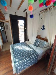 a bedroom with a bed with a canopy at Mancora Apartments in Máncora