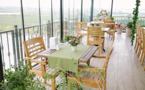 a restaurant with tables and chairs on a balcony at Burgaz İzer Hotel in Lüleburgaz