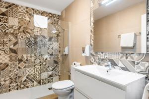 a bathroom with a toilet and a sink at Paloma Beach Apartments in Los Cristianos