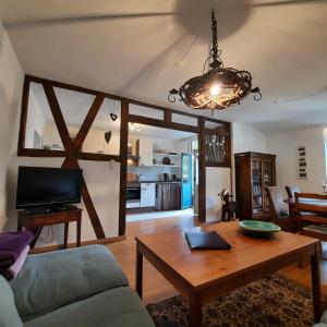 a living room with a couch and a table at FeWo in Ilsenburg Waldblick, schöne Aussicht in Ilsenburg