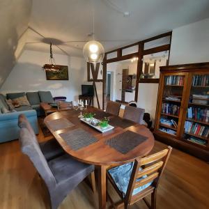 a living room with a wooden table and a couch at FeWo in Ilsenburg Waldblick, schöne Aussicht in Ilsenburg