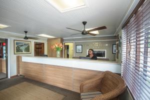 a man standing at a reception desk in a salon at Pine Lodge Resort in Port Elizabeth