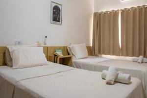 Ein Bett oder Betten in einem Zimmer der Unterkunft Inácios Hotel ltda