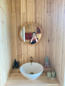 a person taking a picture of a sink in a bathroom at Mã Pì Lèng EcoLodge in Mèo Vạc