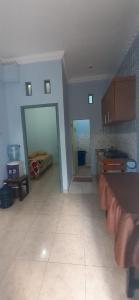a large room with a kitchen and a bedroom at D'House Homestay in Palembang
