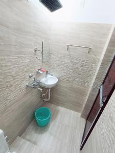a bathroom with a sink and a toilet at Hotel A R S in Patna