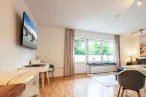 a living room with a television on the wall at Appartement Pier 13 in Tinnum