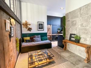 a living room with a couch and a table at Flambantvieux in Saint-Jean-de-Touslas