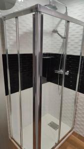 a shower with glass doors in a bathroom at ALAMO LUXURY APARTMENT in Playa del Ingles