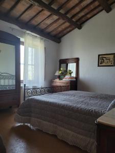 a bedroom with a bed and a mirror and a window at Meridiano 12 in Bolsena