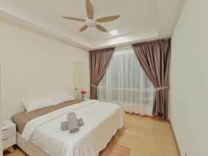 a bedroom with a bed with a ceiling fan and a window at Habibi HoMe KLCC in Kuala Lumpur