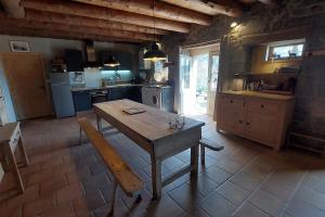 a kitchen with a wooden table in a room at Le Bois Haut in Saint-Jacques-des-Blats +15 photos