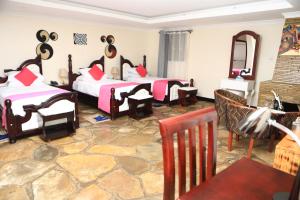 a bedroom with two beds and a mirror at Ingagi Park View Lodge in Kinigi