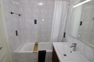 a bathroom with a white tub and a sink at Casa la Pajarera in Ciudad Quesada +16 photos