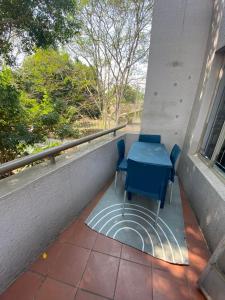 a blue table and chairs sitting on a balcony at HomeSweetHome City Apartment in Nelspruit