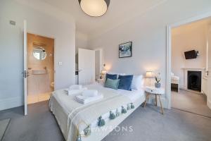 a bedroom with a large bed and a bathroom at Lodge Living by Lawsons with Parking in Windsor