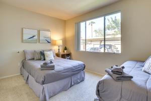 a living room with two beds and a window at Walk to Papago Park Central Phoenix Condo in Phoenix +21 photos