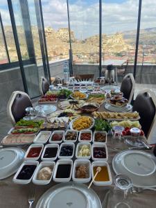 a long table with plates of food on it at Cappadocia Landscape House in Nevsehir