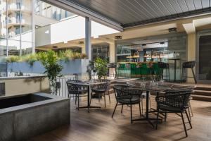 a restaurant with tables and chairs in a building at iQ Hotel Firenze in Florence