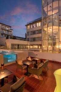 a patio with tables and chairs next to a building at iQ Hotel Firenze in Florence