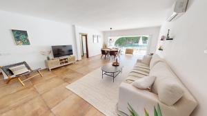 a living room with a couch and a table at El Chaparral - Renovated Villa in La Cala in Mijas Costa