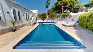 a swimming pool in the backyard of a house at El Chaparral - Renovated Villa in La Cala in Mijas Costa