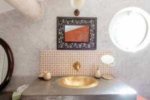 a bathroom with a gold sink and a mirror at Mas de Lure in Salon-de-Provence +32 photos