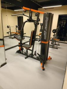 a gym with several tread machines in a room at Aquila Hotel Jeddah Al Hamra in Jeddah