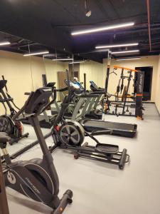 a gym with several treadms and cardio machines at Aquila Hotel Jeddah Al Hamra in Jeddah