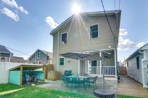 a house with a patio with a table and an umbrella at The 1818 Home with Porch and Grill - 1 Mi to Beach! in Lake Como