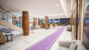 a lobby with couches and a staircase in a building at البرج الأزرق للشقق الفندقية - Blue Tower Hotel Apartments in Riyadh
