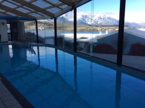 a swimming pool with a view of a mountain at Apartments at Spinnaker Bay in Queenstown