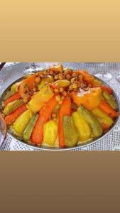 a tray of food with vegetables on a table at Maria Sahara Camp in Merzouga