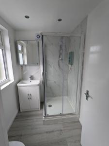 a bathroom with a shower and a sink at 32 in Ashford