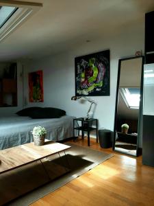 a bedroom with a bed and a table and a mirror at Leça Room in Leça da Palmeira