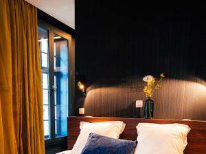 Tempat tidur dalam kamar di Gran Hotel De Passage